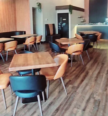 Dining room with wooden tables and tan and black chairs
